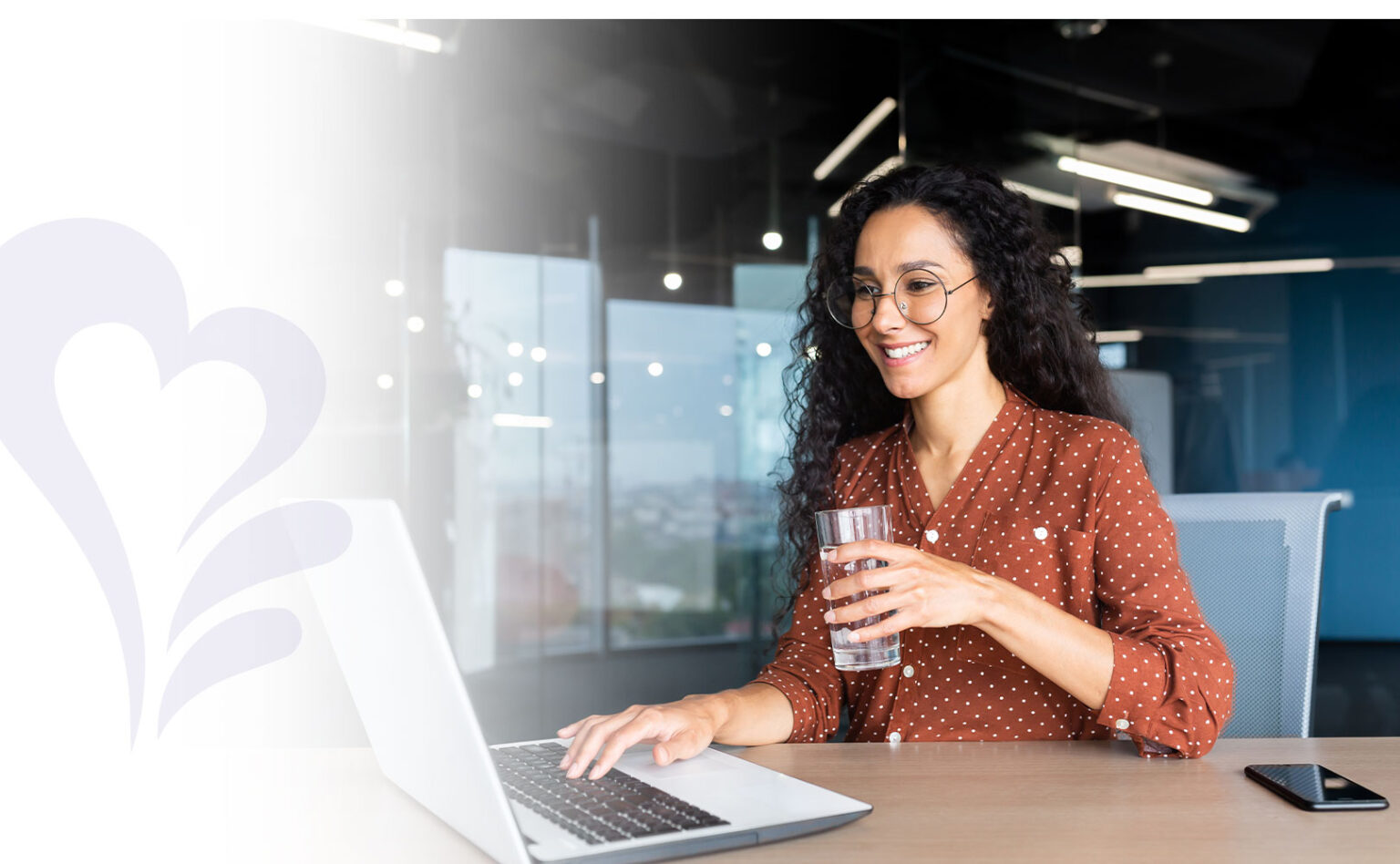 Woman at her computer with a glass of water