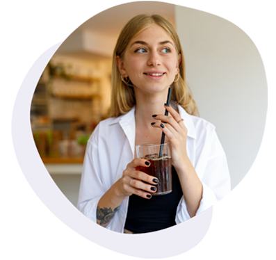 Woman with a full glass of water, holding a straw