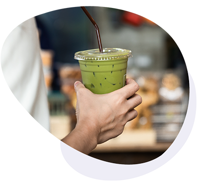 Iced matcha in a plastic up with a straw in it