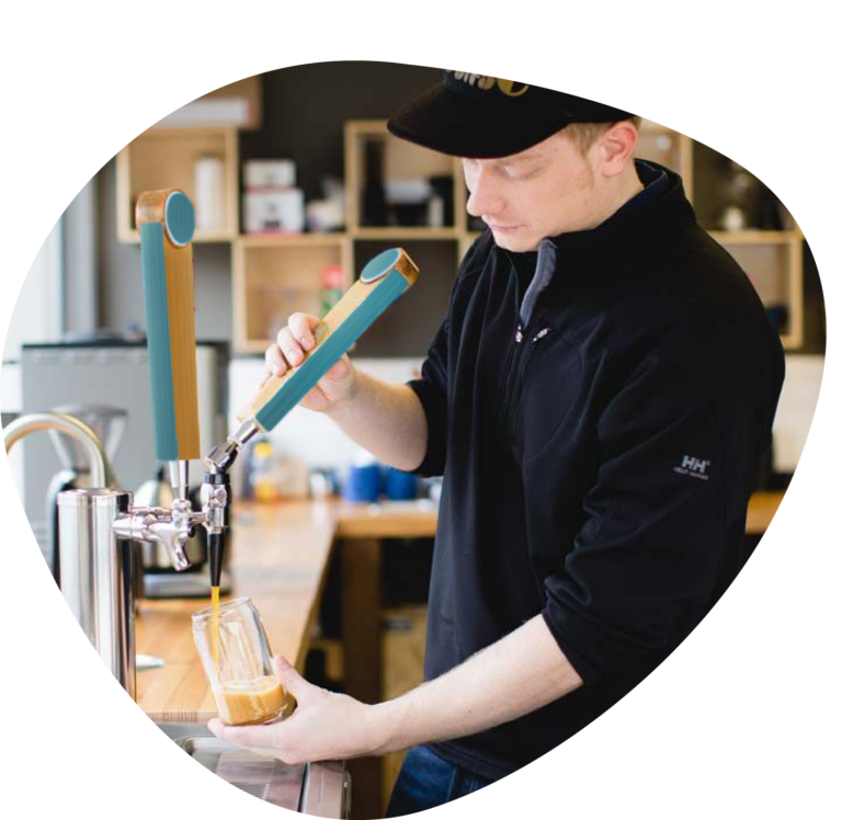 Employee pouring cold brew coffee in an office setting