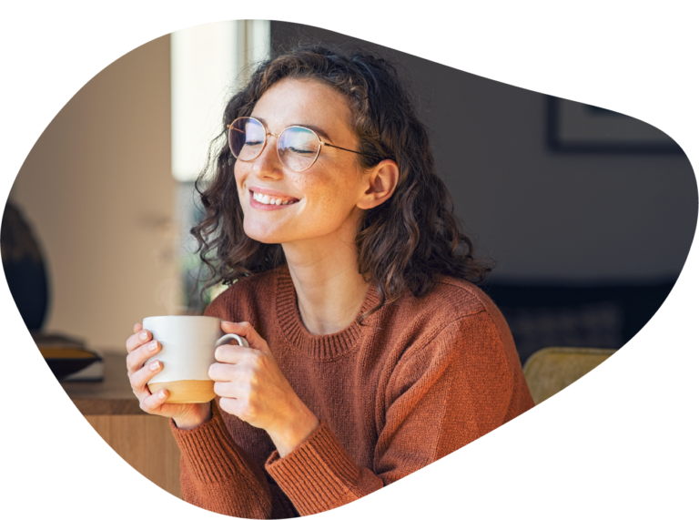 Employee enjoying coffee at her office