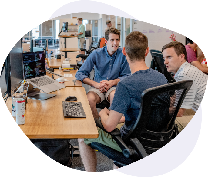 Three man talking in an office setting
